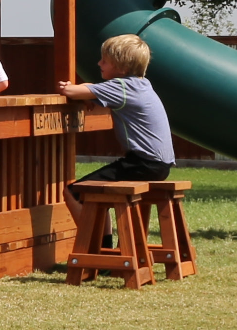 little boy sitting on kids stool, childrens play stool, redwood stool, weplayalot